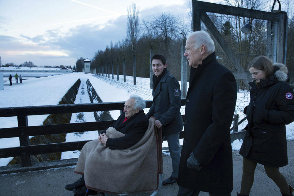 In this image provided by the White House, then-Vice President Joe Biden and his granddaughter Finnegan Biden tour the Nazi concentration camp in Dachau, Germany, with Max Mannheimer, a 95-year-old Holocaust survivor, on Feb. 8, 2015, the person pushing the wheelchair is unidentified. (David Lienemann/White House via AP)