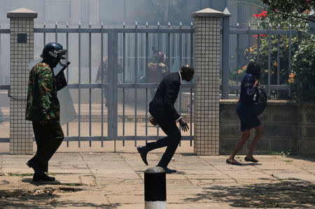 A supporter of opposition National Super Alliance (NASA) coalition runs after riot policemen dispersed them as they participate in a demonstration calling for removal of Independent Electoral and Boundaries Commission (IEBC) officials in Nairobi, Kenya September 26, 2017. REUTERS/Thomas Mukoya