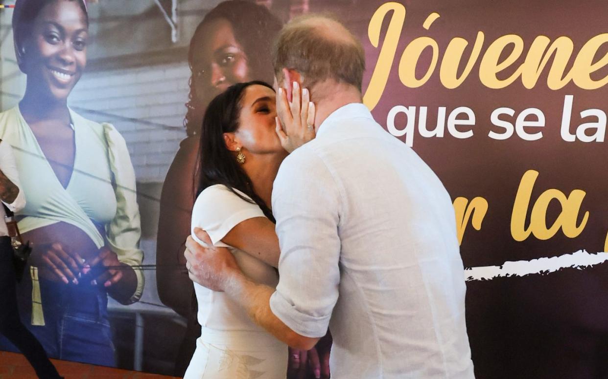 The couple looked relaxed as they shared a kiss and danced with the locals