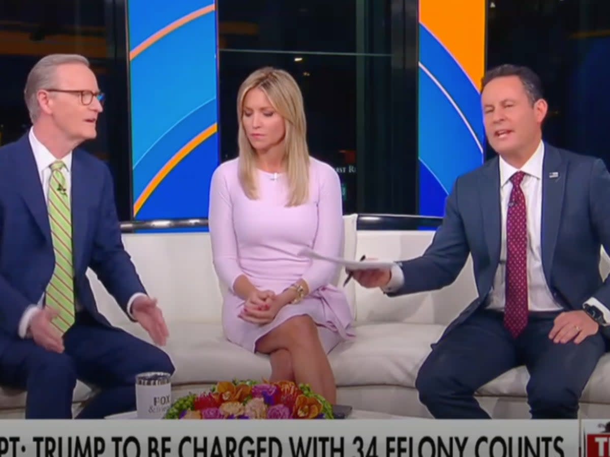 Fox News hosts Doug Doocy and Brian Kilmeade spar in a recent segment on Fox & Friends. Host Ainsley Earhardt, middle, observes. (screengrab/ Fox News)