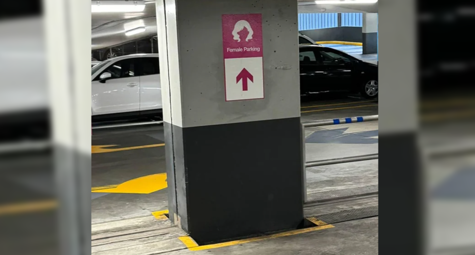 A hot pink female only parking sign against a pillar in the multi-storey car park in Perth.