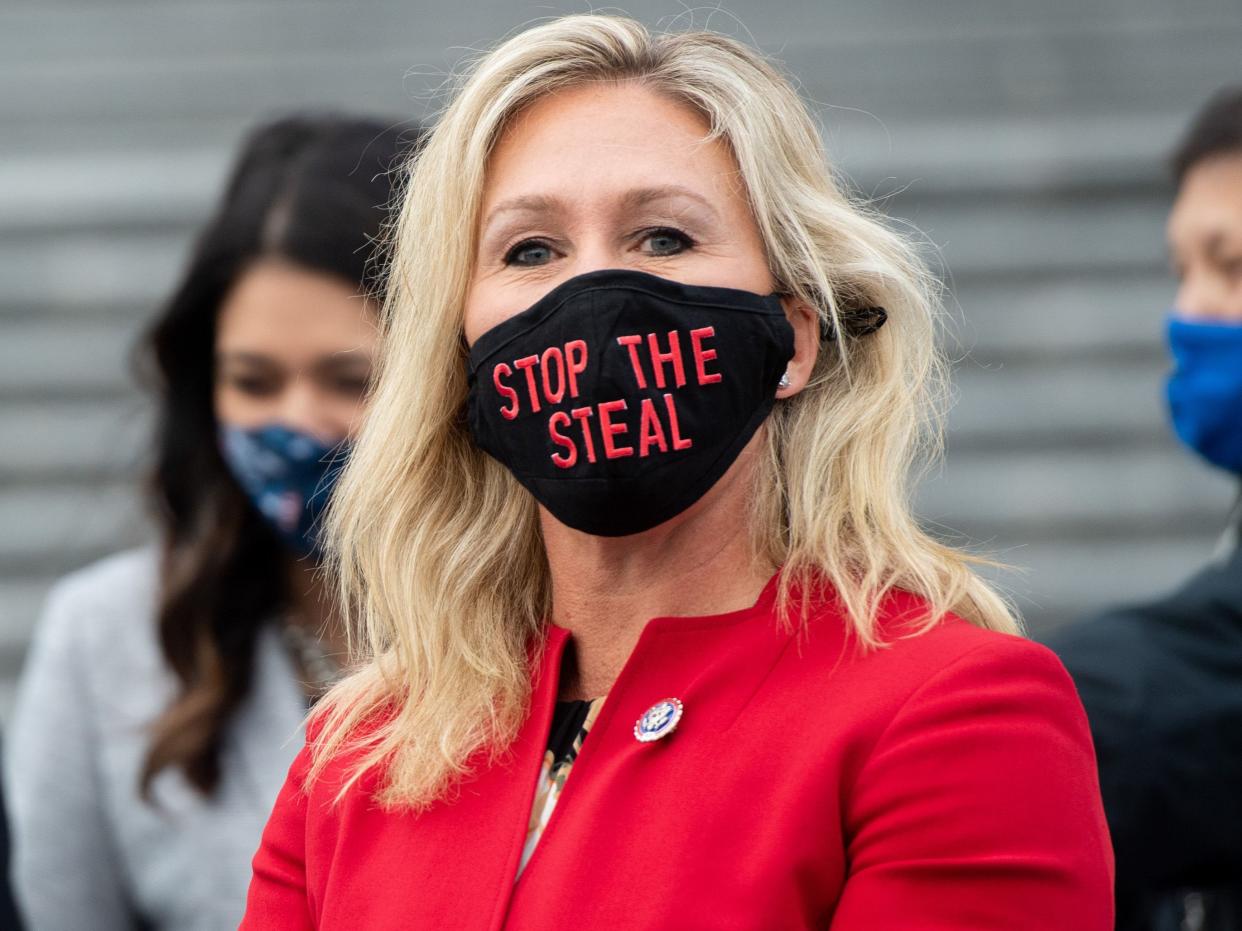 <p>US Representative Marjorie Taylor Greene, Republican of Georgia, wears a “Stop the Steal” mask on the steps of the US Capitol in Washington, DC</p> (AFP via Getty Images)