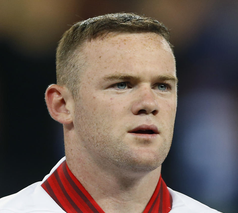 FILE- This Tuesday, June 19, 2012 file photo shows England's Wayne Rooney standing for the anthems ahead of the Euro 2012 soccer championship Group D match between England and Ukraine in Donetsk, Ukraine. On Tuesday, July 24, 2012, British prosecutors announced charges against eight people alleged to have been involved in a phone hacking scheme with more than 600 targets. Some of the prominent alleged victims of the phone hacking are thought to have included, Paul McCartney, Heather Mills, Angelina Jolie, Brad Pitt, Jude Law, Sadie Frost, Sienna Miller, Wayne Rooney, Sven-Goran Eriksson, Lord Frederick Windsor, John Prescott, as well as murdered 13-year old school girl who was abducted in 2002 Amanda "Milly" Dowler. (AP Photo/Kirsty Wigglesworth, File)