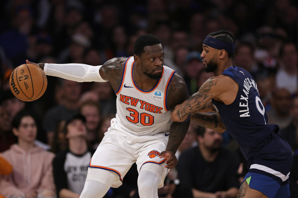 New York Knicks forward Julius Randle (30) looks to drive around Minnesota Timberwolves guard Nickeil Alexander-Walker during the first half of an NBA basketball game, Monday, Jan. 1, 2024, in New York. (AP Photo/Adam Hunger)