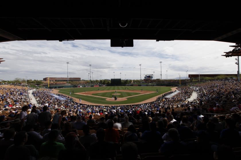 Fans watch an exhibition baseball game at Camelback Ranch between the Los Angeles Dodgers and Chicago White Sox in Glendale, Ariz., Friday, Feb. 28, 2014. (AP Photo/Paul Sancya)