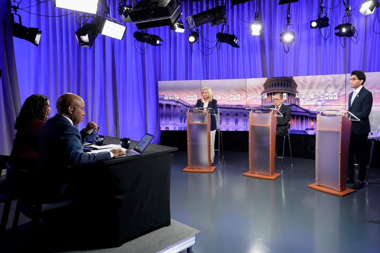 WNYC Senior Politics Reporter Brigid Bergin, foreground left, and NY1 Politics Anchor Errol Louis moderate as Rep. Carolyn Maloney, background left, Rep. Jerry Nadler, center and attorney Suraj Patel debate during New York's 12th Congressional District Democratic primary debate hosted by Spectrum News NY1 and WNYC at the CUNY Graduate Center, Tuesday, Aug. 2, 2022, in New York. (AP Photo/Mary Altaffer, Pool)