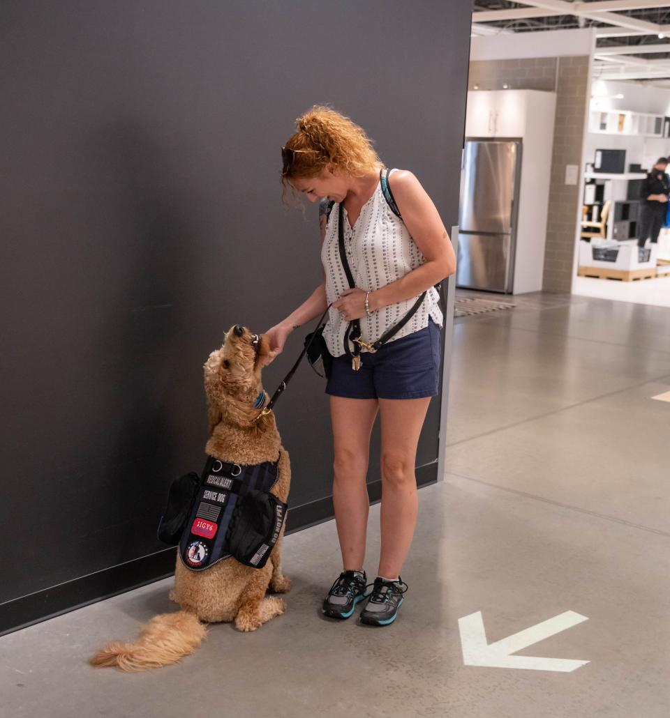 A veteran trains with her service dog, Snickers, at the K9s for Warriors facility.