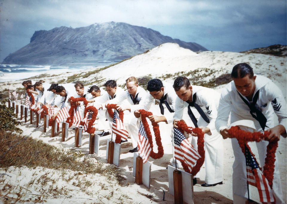 <p>Following Hawaiian tradition, Sailors honor men killed during the Japanese Pearl Harbor attack the previous year on Naval Air Station Kaneohe, Hawaii on May 31, 1942.The casualties had been buried on December 8, 1941. (U.S. Navy/National Archives/Handout via Reuters) </p>