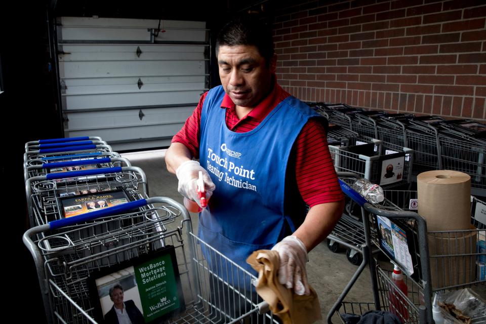 Kroger worker Desiderio Reynoso Morales disinfects shopping carts at a store in Newport, Kentucky, in 2020.