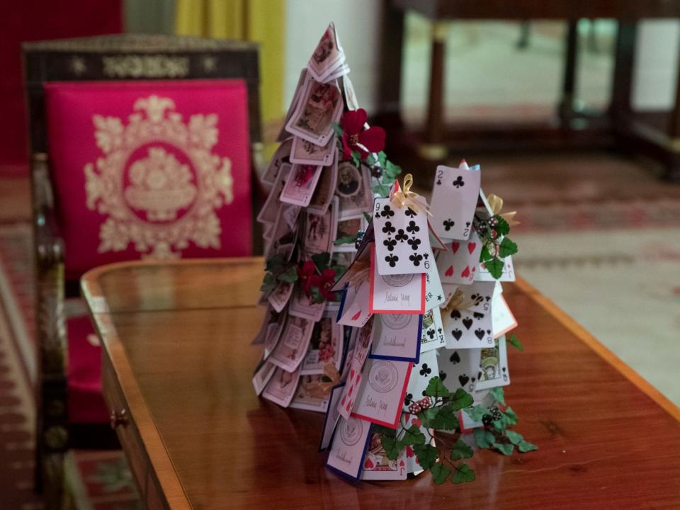 The Red Room decorated with games, including a tree made of White House playing cards.
