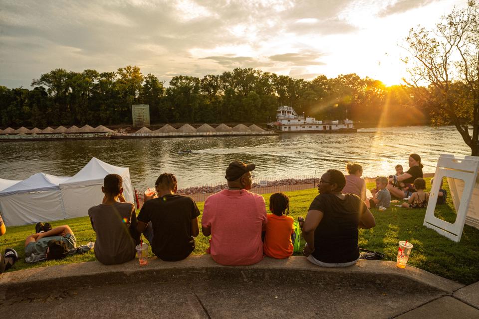 Families sit on the banks of the river during the 33rd annual Riverfest in Clarksville, Tenn., on Sep. 9, 2022. Riverfest is a free and open to the public event that draws in more then 30,000 people every year with live music, food, drinks and shopping.