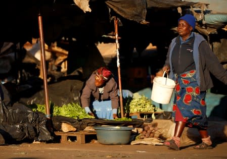 Women are seen at a vegetable market, after Zimbabwe police banned an anti-government demonstration, in Bulawayo
