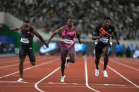 Akani Simbine of South Africa, left, finishes first, with Christian Coleman of the United States, centre, and Fred Kerley of the United States, winning silver and bronze respectively, in the men's 100-meters final during the Diamond League event held in Suzhou in eastern China's Jiangsu province Saturday, April 27, 2024. (AP Photo/Ng Han Guan)