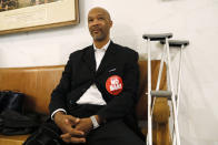 Floyd Trammell, a pastor at First Friendship Baptist Church, waits outside the chambers prior to the board of supervisors vote on the nation's first ban of e-cigarette sales on Tuesday, June 18, 2019, at City Hall in San Francisco. He wears a "no ban" sticker to oppose the measures. San Francisco supervisors unanimously voted to move the city toward becoming the first in the United States to ban all sales of electronic cigarettes in an effort to crack down on youth vaping. The plan would ban the sale and distribution of e-cigarettes, as well as prohibit e-cigarette manufacturing on city property. (AP Photo/Samantha Maldonado)