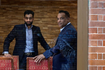 Abdul Ahad, owner of the City Spice curry house, poses for a photograph with his son, also Abdul Ahad, at their restaurant on Brick Lane in London, Britain January 7, 2019. Picture taken January 7, 2019. REUTERS/Simon Dawson