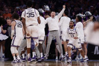 Kansas State team members react after defeating Michigan State in overtime of a Sweet 16 college basketball game in the East Regional of the NCAA tournament at Madison Square Garden, Thursday, March 23, 2023, in New York. (AP Photo/Adam Hunger)