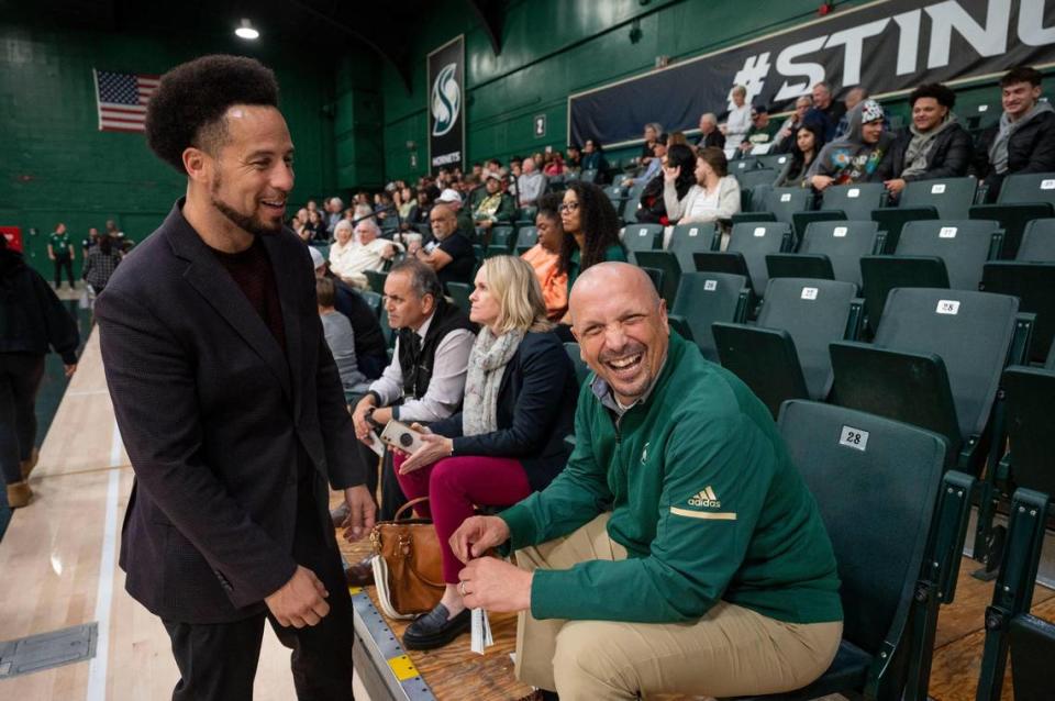 Sacramento State president Luke Wood laughs with athletic director Mark Orr during haltime Tuesday during the first men’s basketball game of the season against the Pacific Union Pioneers. After decades of trying to get a new arena on campus, Sacramento State has plans to play elsewhere on campus starting next season, meaning an end for their old gym, The Nest.