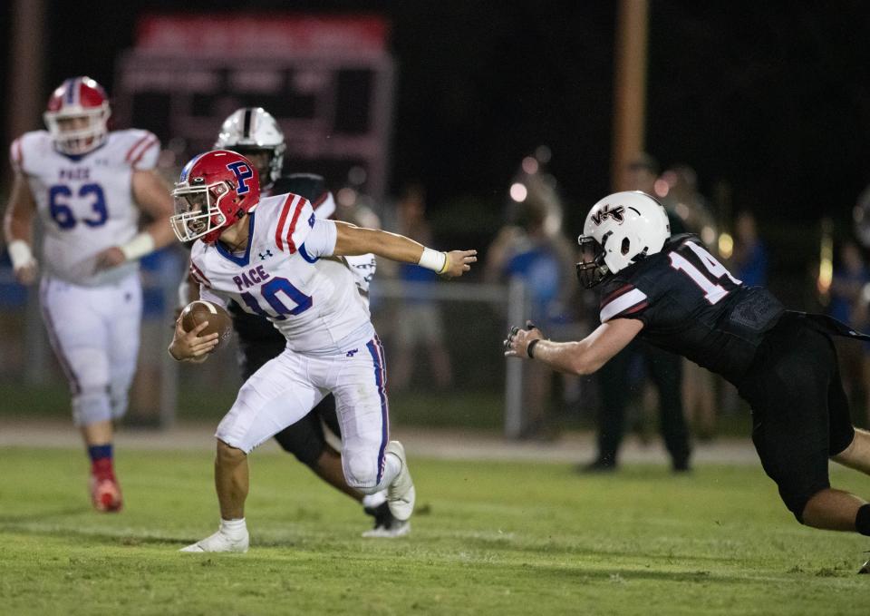 Quarterback Nick Simmons (10) keeps the ball during the Pace vs West Florida football game at West Florida High School in Pensacola on Friday, Sept. 8, 2023.