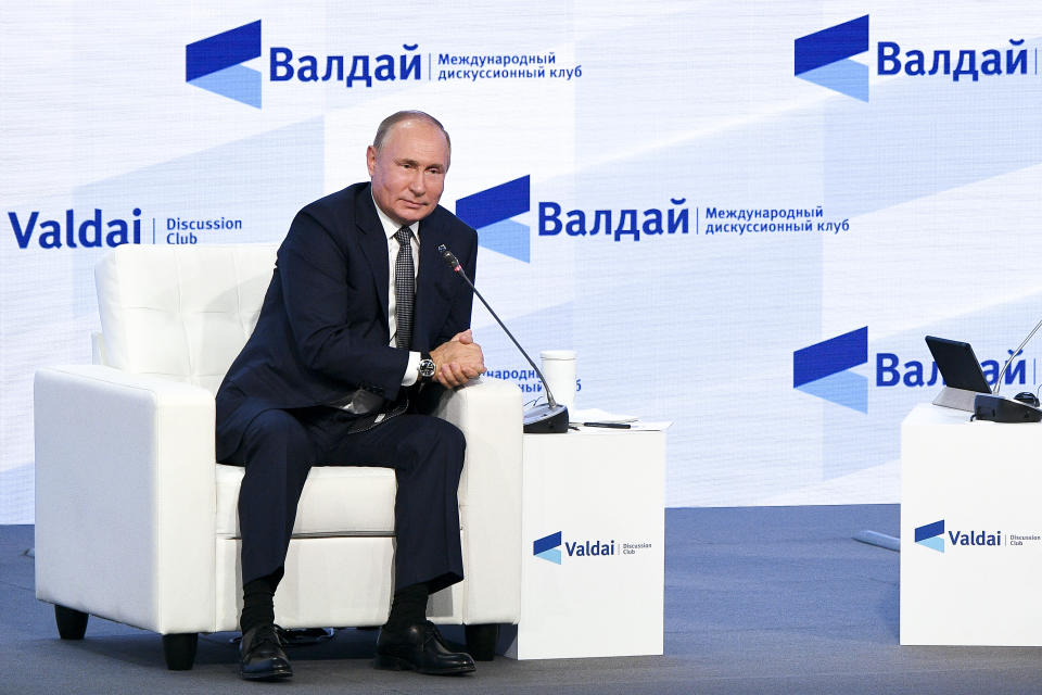 Russian President Vladimir Putin gestures attends the annual meeting of the Valdai Discussion Club in the Black Sea resort of Sochi, Russia, Thursday, Oct. 21, 2021. President Vladimir Putin has voiced consternation about Russians' hesitancy to get vaccinated and urged them to get the shots, adding: "Why wait for the illness and its grave consequences?" (Maksim Blinov, Sputnik, Kremlin Pool Photo via AP)