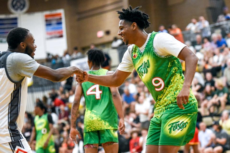 Team Faygo and Michigan State's AJ Hoggard, right, celebrates with MSU teammate Tre Holloman after Hoggard's three straight 3-pointer against Team 5 Star Zone during the Moneyball Pro-Am on Thursday, July 13, 2023, at Holt High School.