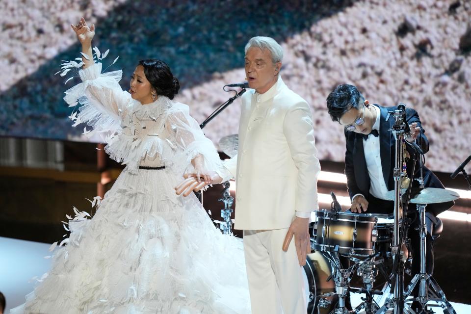 David Byrne, right, and Stephanie Hsu, left along with music trio Son Lux perform the Oscar nominated original song.