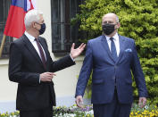 Poland's Foreign Minister Zbigniew Rau,right, gestures toward Slovak Foreign Minister Ivan Korcok, ahead of a meeting with regional counterparts in Lodz, Poland, Friday, May 14, 2021.(AP Photo/Czarek Sokolowski)