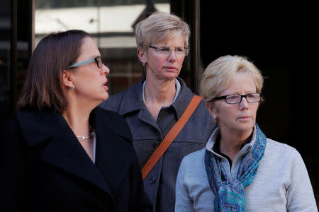 Donna Heinel (C), former associate athletic director at the University of Southern California (USC) facing charges in a nationwide college admissions cheating scheme, leaves the federal courthouse in Boston, Massachusetts, U.S., March 25, 2019. REUTERS/Brian Snyder