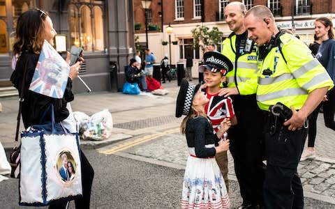 Young royal fans pose for a picture with police officers in Windsor - Credit: John Nguyen for The Telegraph