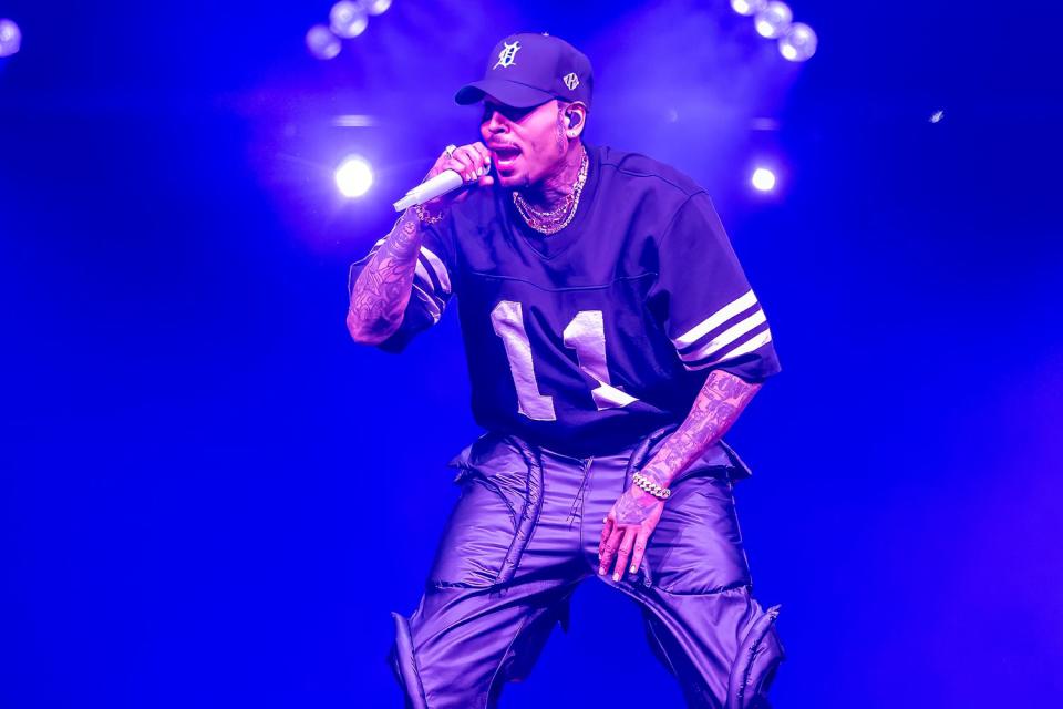 <p>Scott Legato/Getty</p> Chris Brown performs in Detroit on June 5, 2024