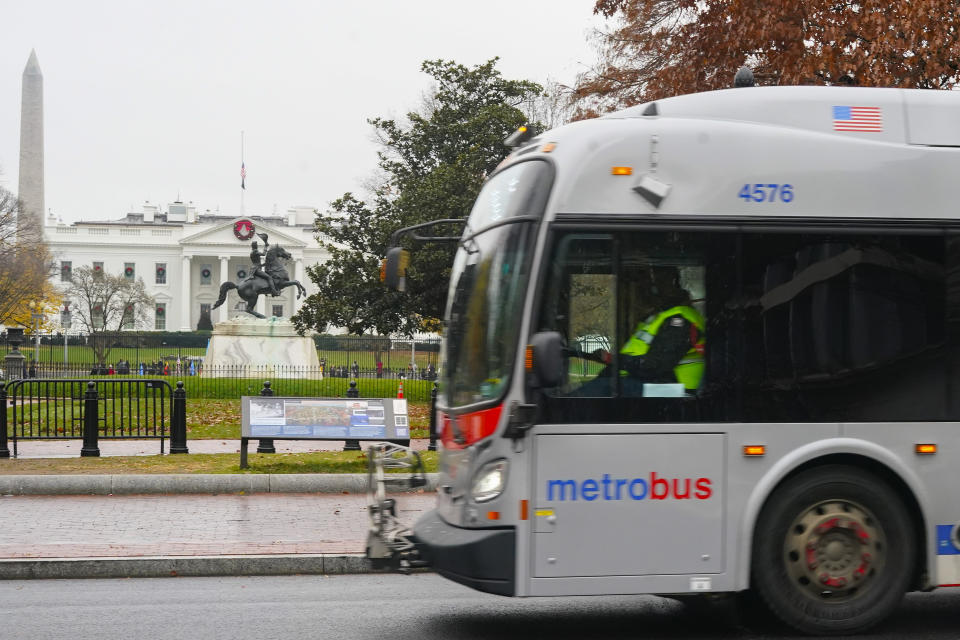 A Metrobus moves past the White House in Washington, Wednesday, Dec. 7, 2022. The Washington DC government voted to waive fares for Metrobus rides within city limits starting July, 1, 2023, becoming the nation's most populous city to offer free public transit. (AP Photo/Pablo Martinez Monsivais)