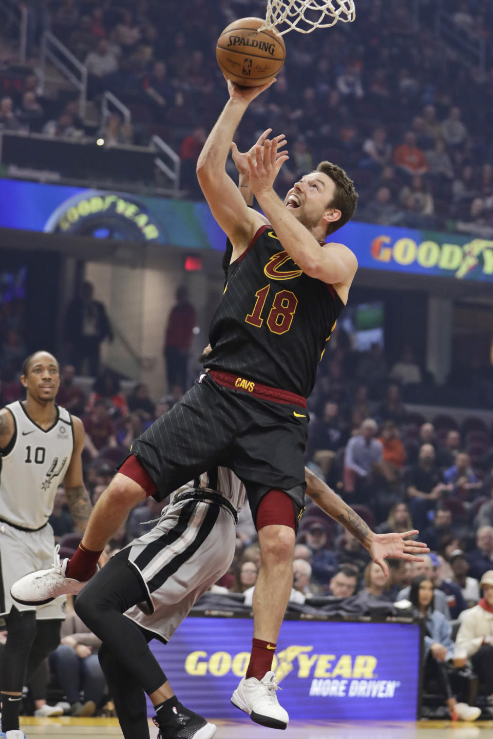 Cleveland Cavaliers' Matthew Dellavedova (18) drives to the basket against the San Antonio Spurs in the first half of an NBA basketball game, Sunday, March 8, 2020, in Cleveland. (AP Photo/Tony Dejak)