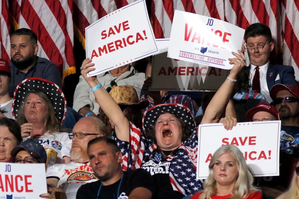 A woman in the crowd cheers during the Save America campaign rally in Youngstown, Ohio (AP)