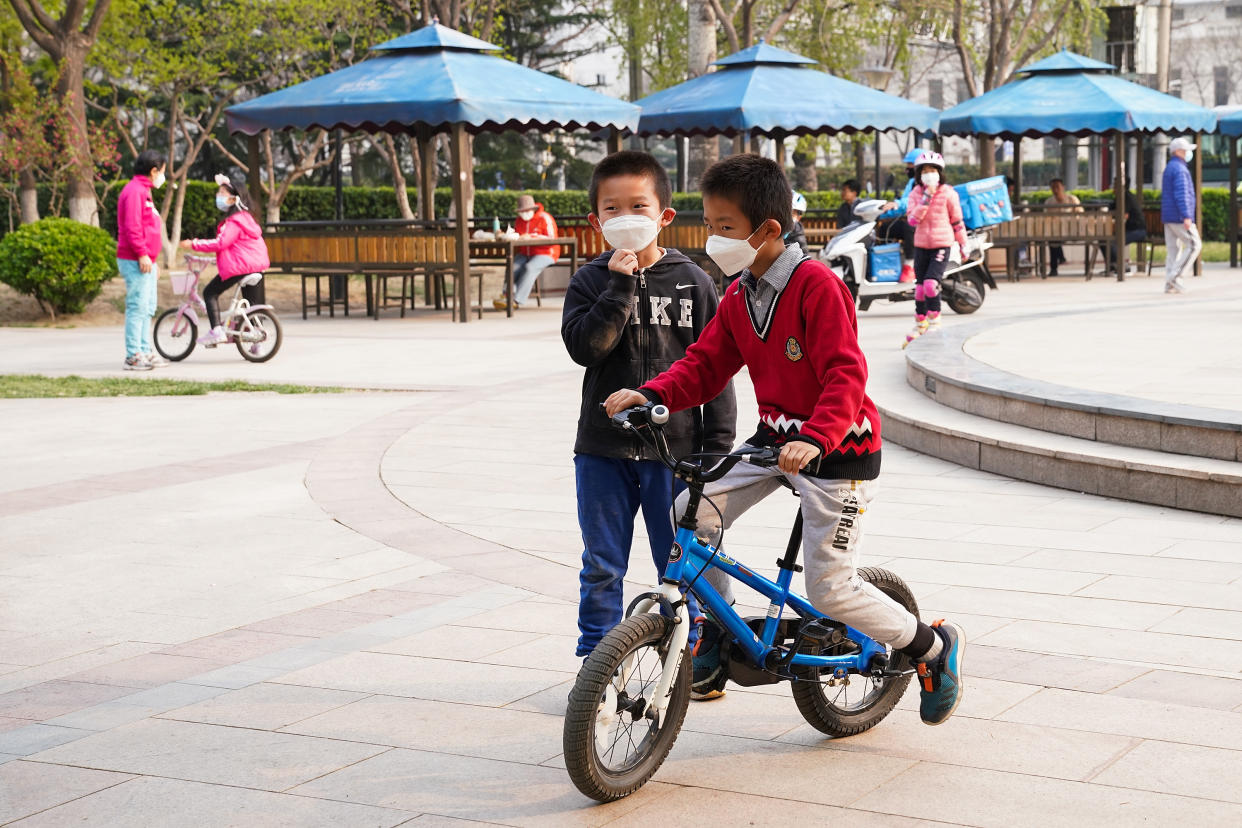 BEIJING, CHINA - MARCH 31: Young Chinese children wear protective masks as they playing in the garden on March 31, 2020 in Beijing, China. The Coronavirus (COVID-19) pandemic has spread to at least 185 countries, claiming over 3,8000 lives and infecting hundreds of thousands more. (Photo by Lintao Zhang/Getty Images)