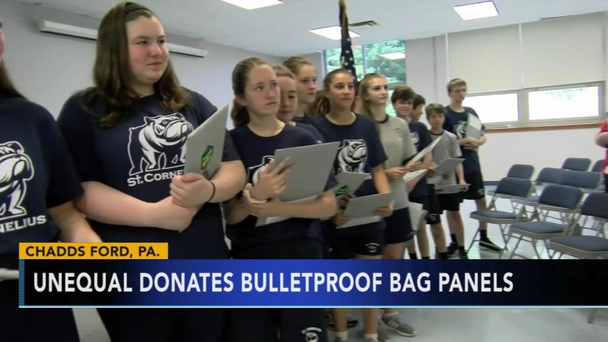 Middle school graduates receive a bulletproof shield that their principal hopes they will carry in high school. (Photo: San Francisco KGO)