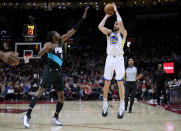 Golden State Warriors guard Klay Thompson, right, shoots a 3-pointer over Portland Trail Blazers forward Jerami Grant during the first half of an NBA basketball game in Portland, Ore., Wednesday, Feb. 8, 2023. (AP Photo/Craig Mitchelldyer)