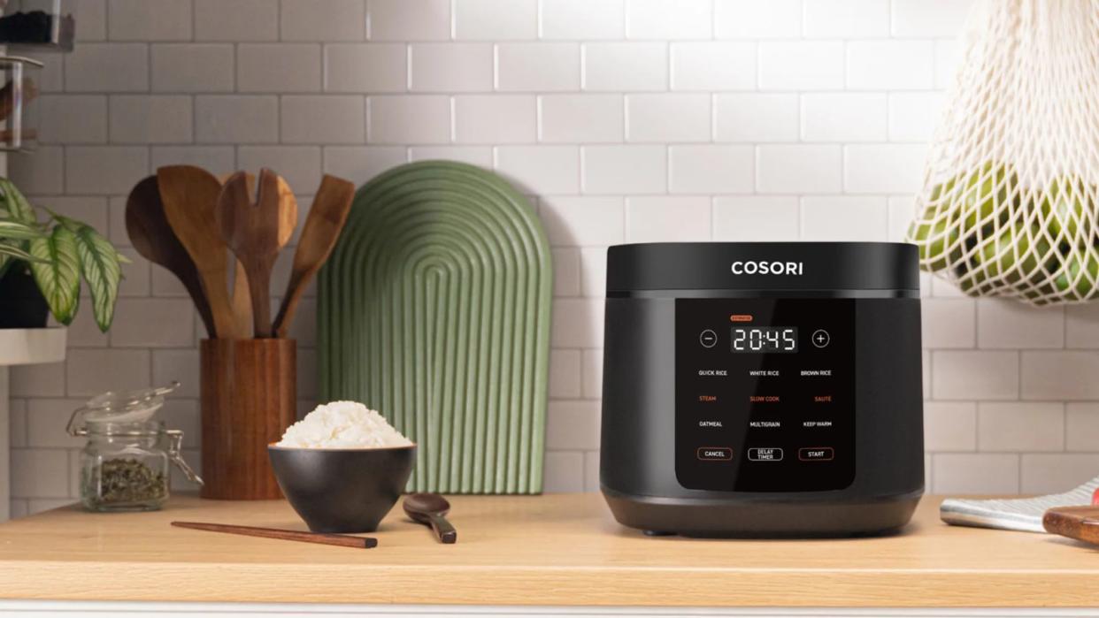  A Cosori 5-Quart Rice Cooker on a countertop with a bowl of white rice. 