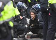 A protester is assisted by police after being injured during protests near the inauguration of President-elect Donald Trump in Washington, DC, U.S., January 20, 2017. REUTERS/Bryan Woolston