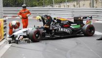 Force India Formula One driver Sergio Perez leaves his car after crashing at the start of the Monaco F1 Grand Prix in Monaco, May 25, 2014. REUTERS/Robert Pratta (MONACO - Tags: SPORT MOTORSPORT F1)