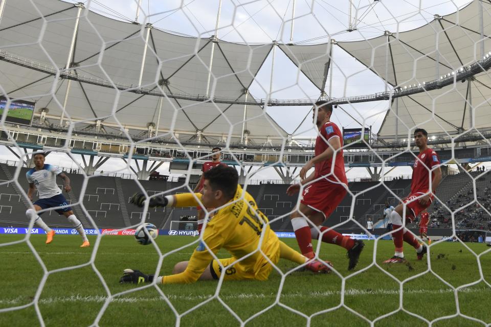 Tunisia's goalkeeper Dries Arfaoui, center, blocks a shot by England's Daniel Jebbison, left, during a FIFA U-20 World Cup Group E soccer match at Diego Maradona stadium in La Plata, Argentina, Monday, May 22, 2023. (AP Photo/Gustavo Garello)