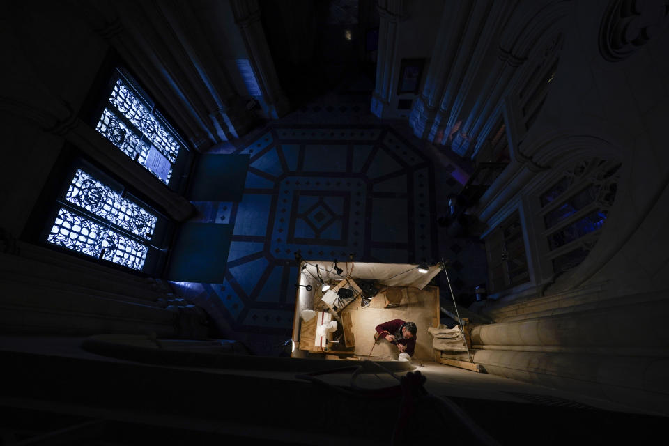 Washington National Cathedral stone carver Sean Callahan works on a sculpture of Holocaust survivor and Nobel Peace Prize winning author Elie Wiesel on a scaffold in the Human Rights Porch at the cathedral in Washington, Thursday, April 1, 2021. The carving completes a quartet of heads of prominent figures sprouting from the four corners of an alcove known as the Human Rights Porch, joining Mother Teresa, Rosa Parks and Jonathan Myrick Daniels, a young Episcopal theologian and civil rights crusader who was shot to death in Alabama in 1965, giving his life to protect a 17-year-old Black woman. (AP Photo/Carolyn Kaster)