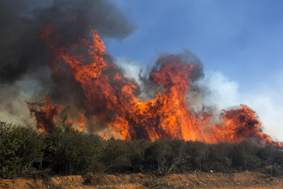 The Apple Fire burns in Cherry Valley, Calif., Saturday, Aug. 1, 2020.A wildfire northwest of Palm Springs flared up Saturday afternoon, prompting authorities to issue new evacuation orders as firefighters fought the blaze in triple-degree heat. (AP Photo/Ringo H.W. Chiu)