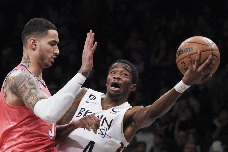 Brooklyn Nets guard Edmond Sumner, right, drives to the basket against Washington Wizards forward Kyle Kuzma during the first half of an NBA basketball game, Saturday, Feb. 4, 2023, in New York. (AP Photo/Bebeto Matthews)