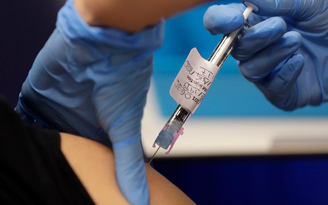 A volunteer is injected with a trial coronavirus vaccine as part of an Imperial College vaccine trial -  Kirsty Wigglesworth / AP