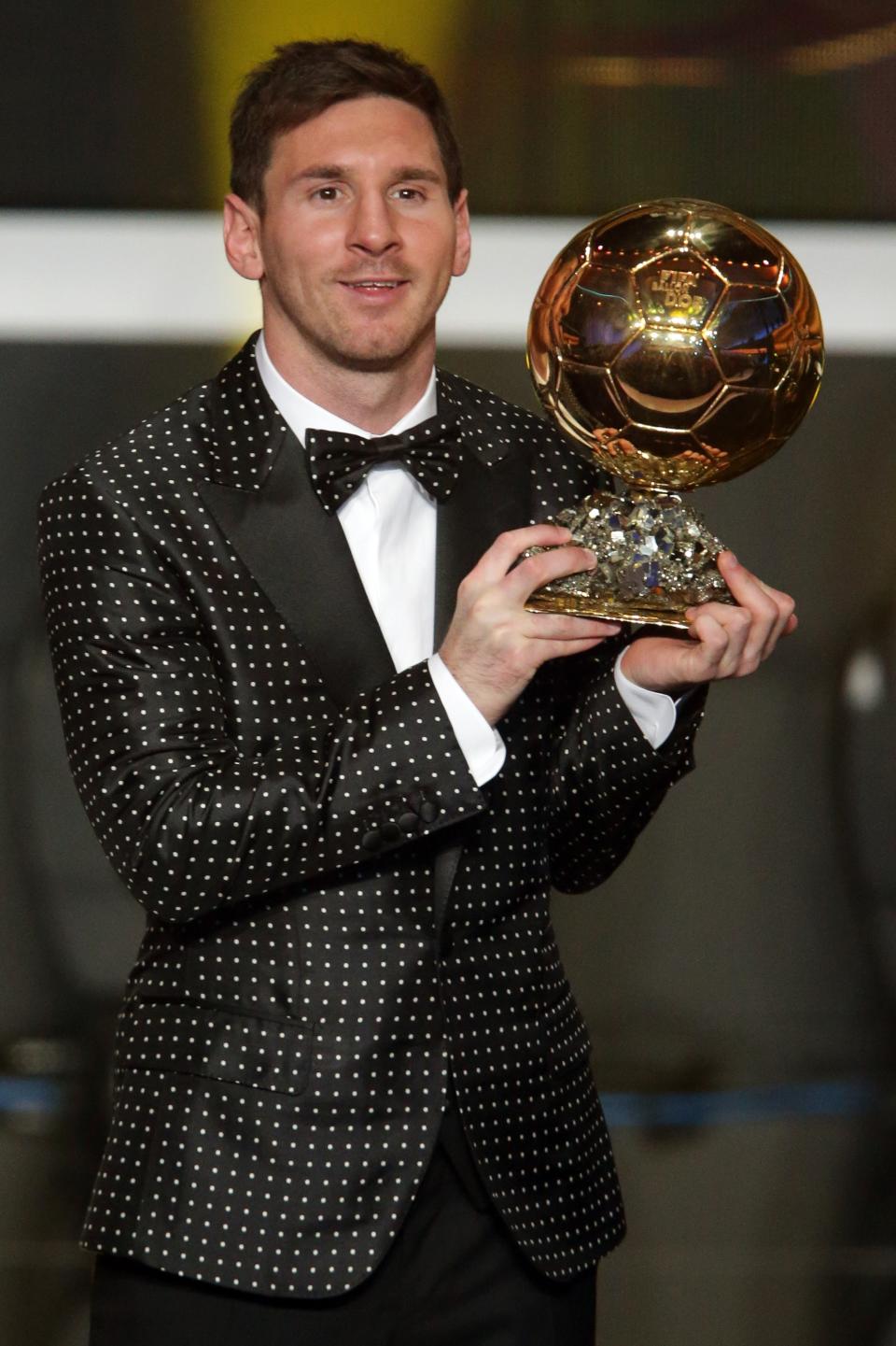 ZURICH, SWITZERLAND - JANUARY 07: Lionel Messi of Argentina receives the FIFA Ballon d'Or 2012 trophy on January 7, 2013 in Zurich, Switzerland. (Photo by Christof Koepsel/Getty Images)