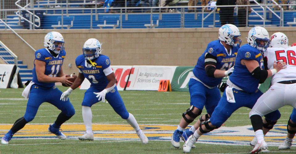 Mark Gronowski fakes a handoff to Amar Johnson during Saturday's 31-7 win over Illinois State at Dana J. Dykhouse Stadium