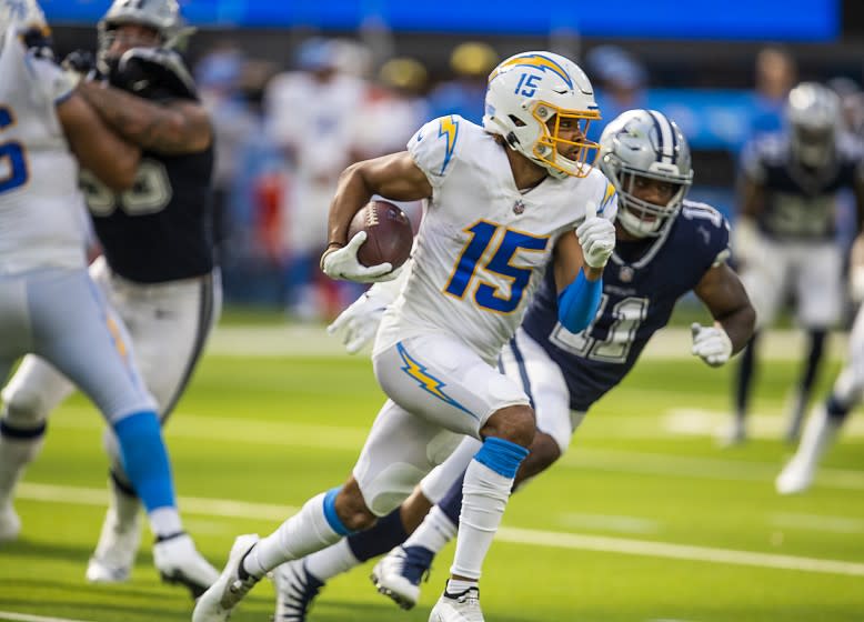 Los Angeles, CA - September 19: Los Angeles Chargers wide receiver Jalen Guyton, center, runs past Dallas Cowboy.