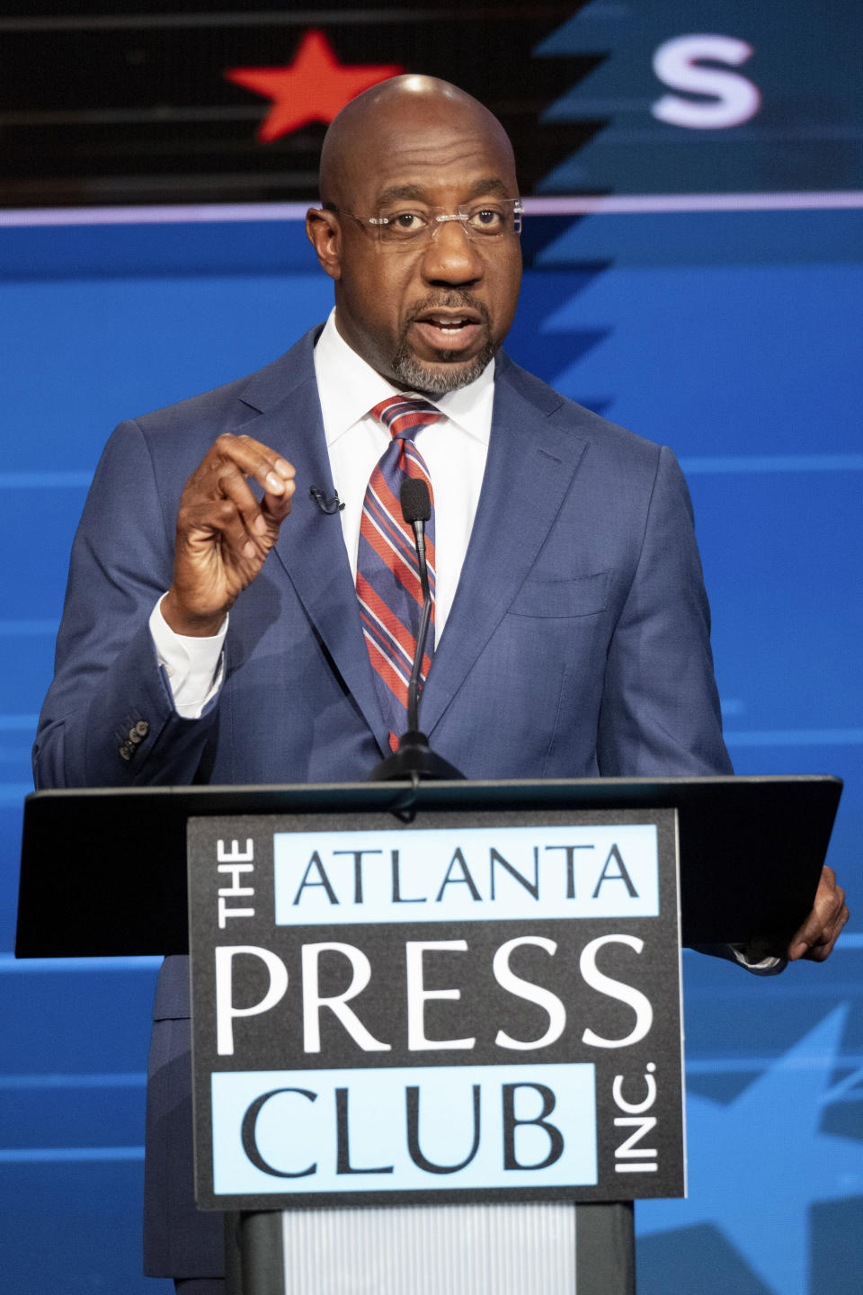 Sen. Raphael Warnock, D-Ga., speaks during a U.S. Senate debate with Libertarian challenger Chase Oliver during the Atlanta Press Club Loudermilk-Young Debate Series in Atlanta on Sunday, Oct. 16, 2022. Republican challenger Herschel Walker was invited but did not attend. (AP Photo/Ben Gray)