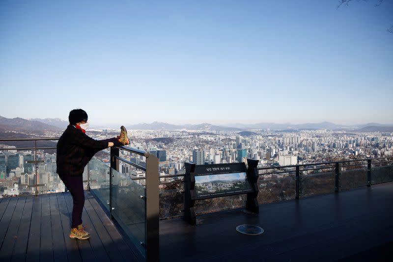 A woman stretches on the top of Mt. Nam amid the coronavirus disease (COVID-19) pandemic in Seoul