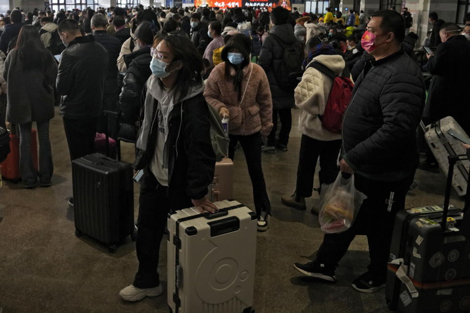 Travelers arrive at a departure hall to catch their trains at the West Railway Station in Beijing, Sunday, Jan. 15, 2023. The World Health Organization has appealed to China to keep releasing information about its wave of COVID-19 infections after the government announced nearly 60,000 deaths since early December following weeks of complaints it was failing to tell the world what was happening. (AP Photo/Andy Wong)