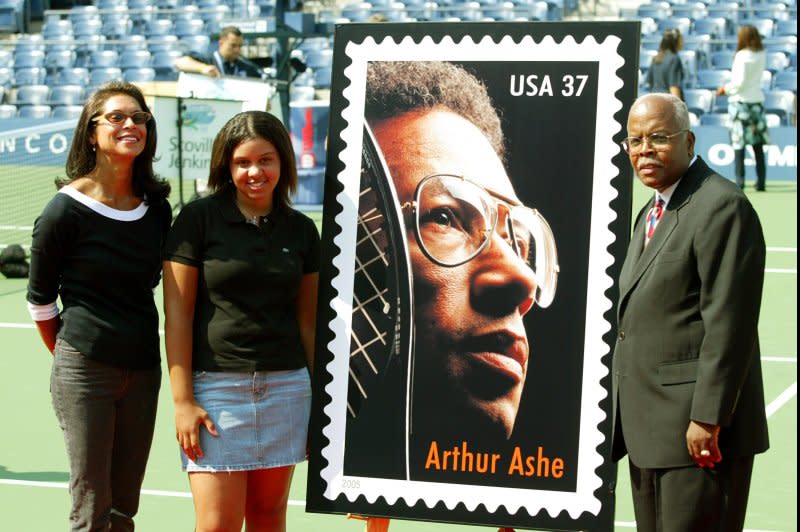 Jeannie Ashe (L), Carmen Ashe and Vice President of the U.S. Postal Service Ken Pankey unveil the new Arthur Ashe postage stamp during Arthur Ashe Kids Day in Flushing, N.Y., on August 28, 2004. On July 5, 1975, Arthur Ashe became the first African-American man to win the Wimbledon singles title. File Photo by John Angelillo/UPI